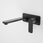 Caroma Luna black wall-mounted basin/bath mixer tap with paddle handle, side view on white background