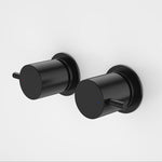 Caroma Luna black wall top tap handle set, round cylindrical lever pair for shower or bath, wall mounted on white background