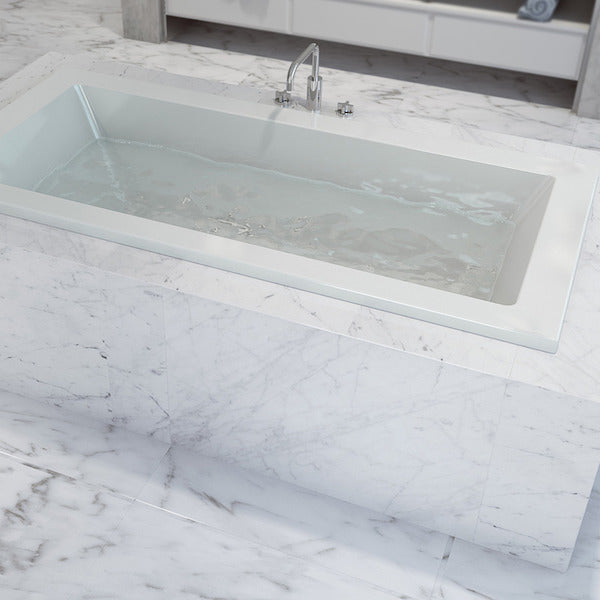 Caroma Newbury white rectangular island bath inset in marble-look tiled hob with centre tap and waste holes
