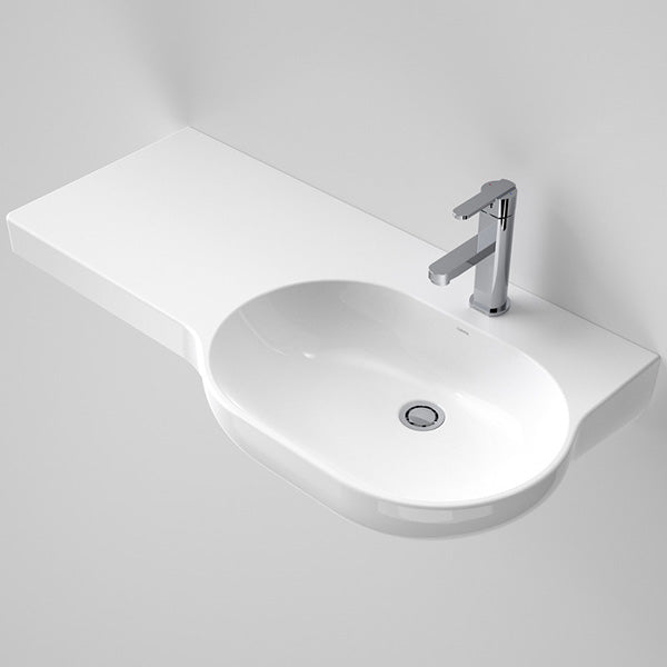 Caroma Opal wall-hung basin, gloss white oval ceramic with right-hand shelf and one taphole, shown in angled view.