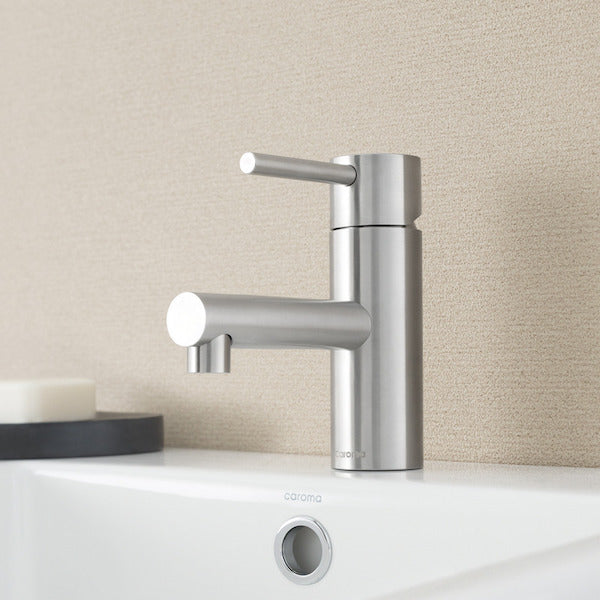Caroma Titan stainless steel basin mixer, satin finish, shown installed on a white bathroom basin