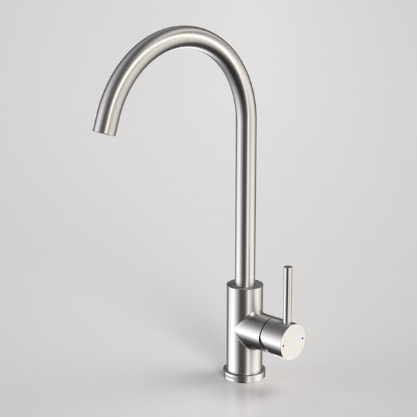 Caroma Titan stainless steel gooseneck sink mixer tap with swivel spout and side lever, satin finish on grey background