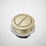 Caroma round metal cistern flush button in brushed brass finish, shown on white background
