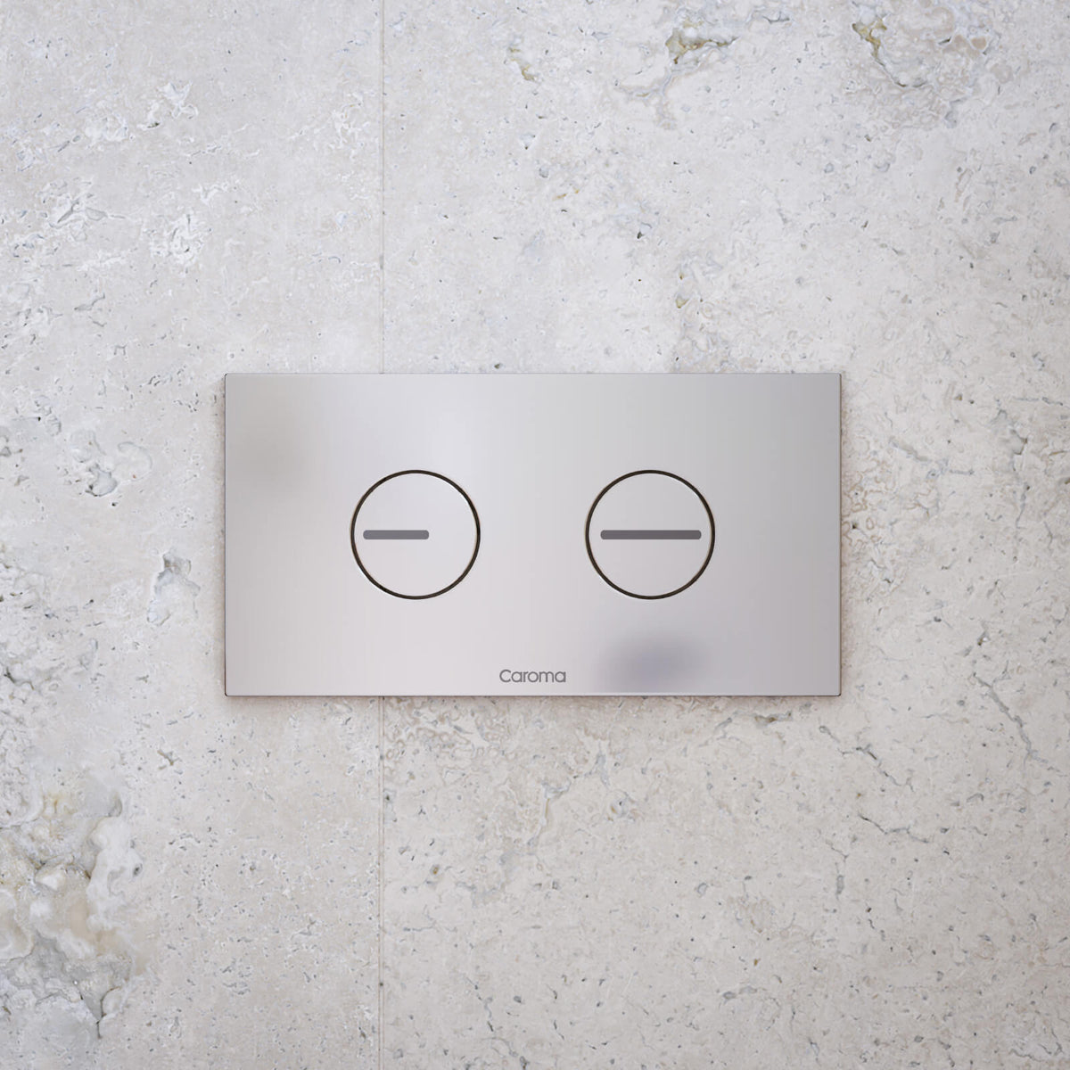 Caroma white dual flush toilet button plate on stone-look wall, rectangular concealed cistern flush panel, front view