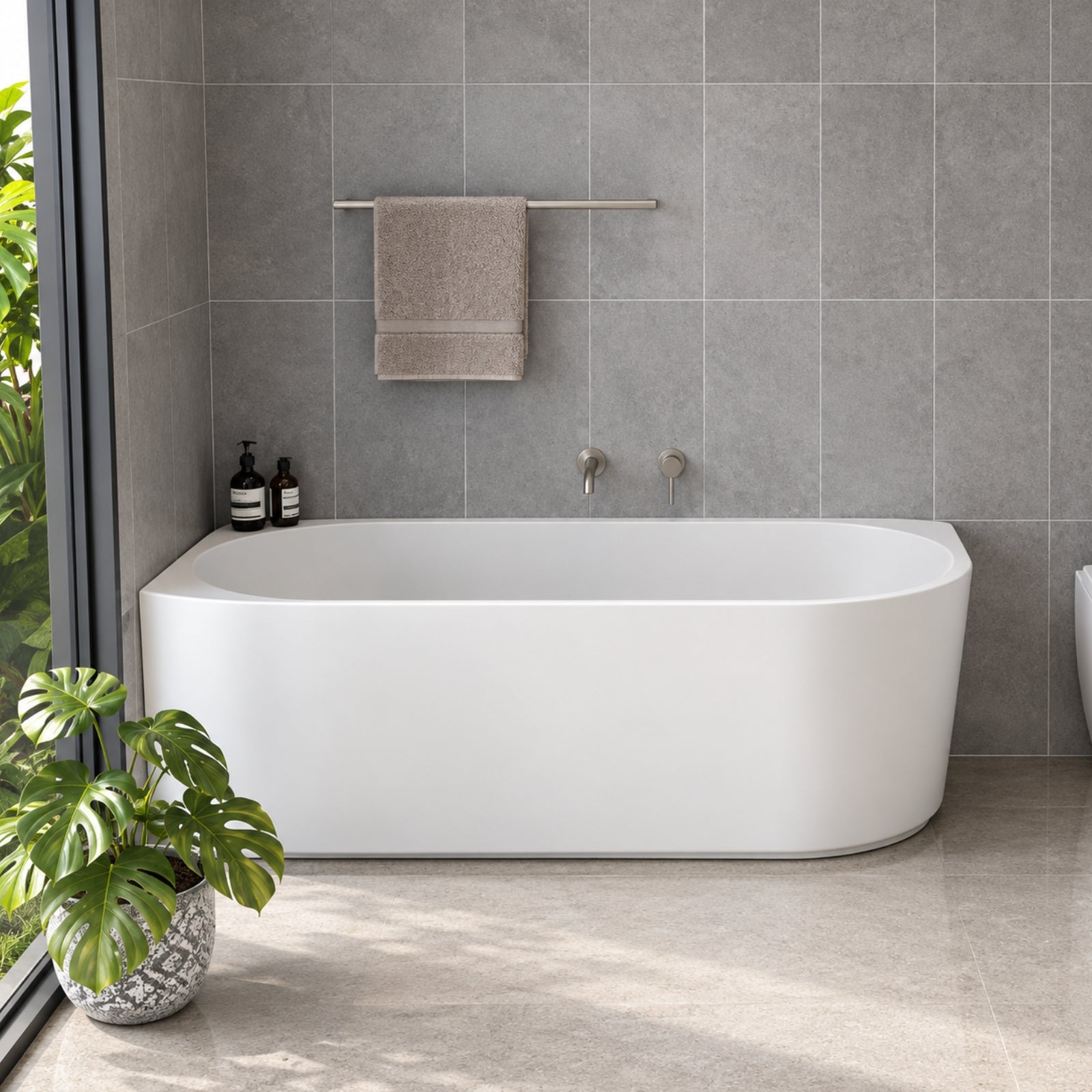Caroma Urbane II white corner back-to-wall bath in a tiled bathroom, with oval shape and right-hand corner profile