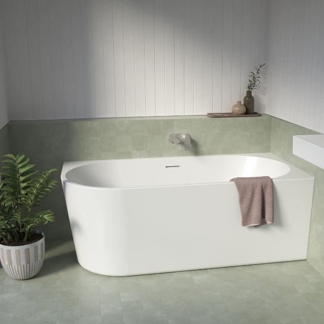Caroma Urbane II white corner back to wall bath with overflow in a bathroom setting, oval acrylic design