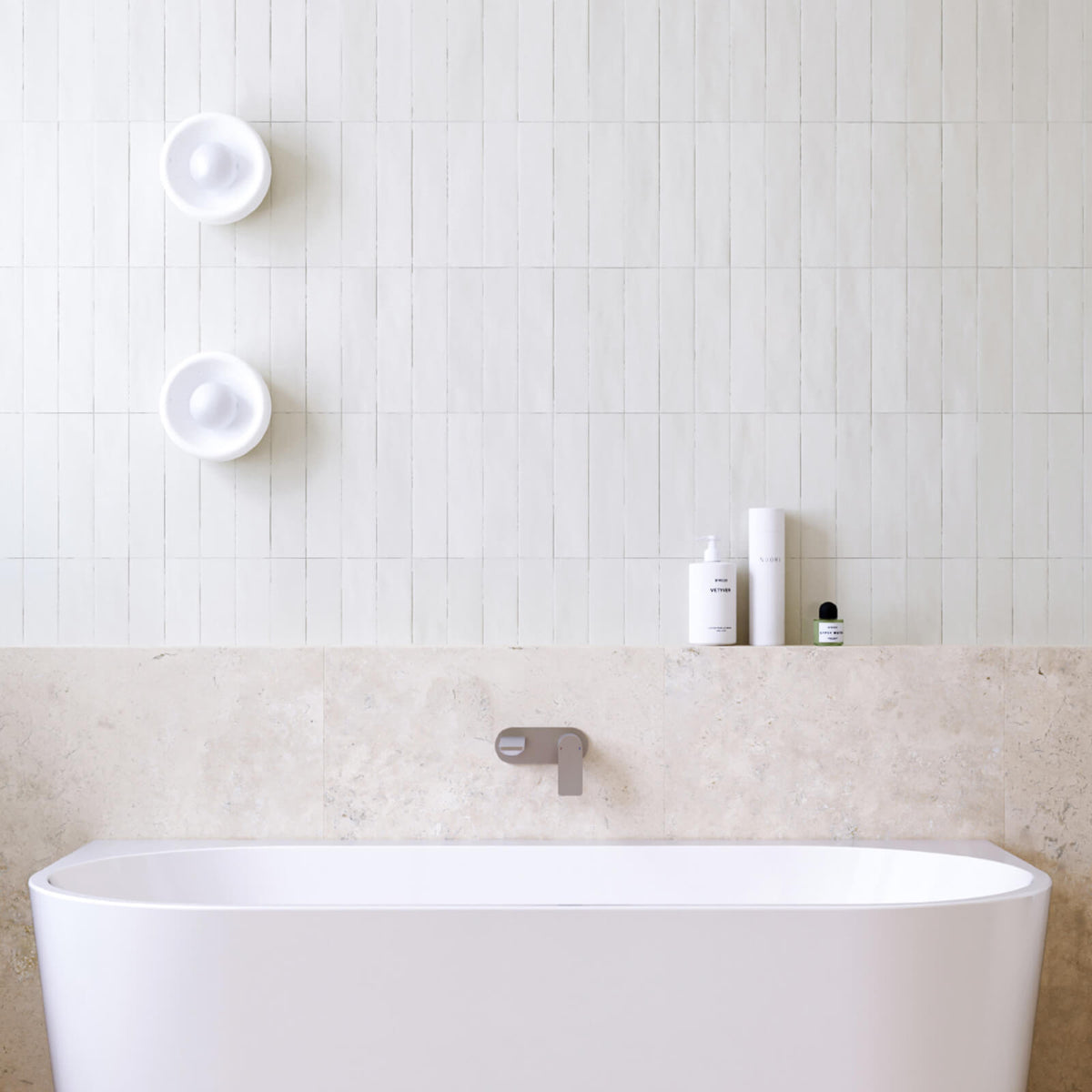 Caroma Urbane II wall basin/bath mixer in brushed nickel over a white round basin, shown in a bathroom vanity setting