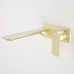 Caroma Urbane II wall basin/bath mixer in brushed brass, with rectangular spout and lever handle on wall plate