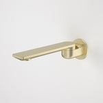Caroma Urbane II round bath swivel outlet in brushed brass, shown side on with a long flat spout and round wall plate