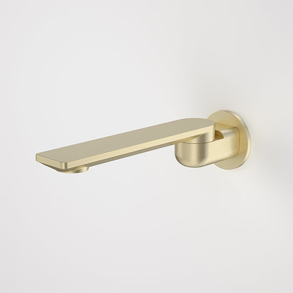 Caroma Urbane II round bath swivel outlet in brushed brass, shown side on with a long flat spout and round wall plate