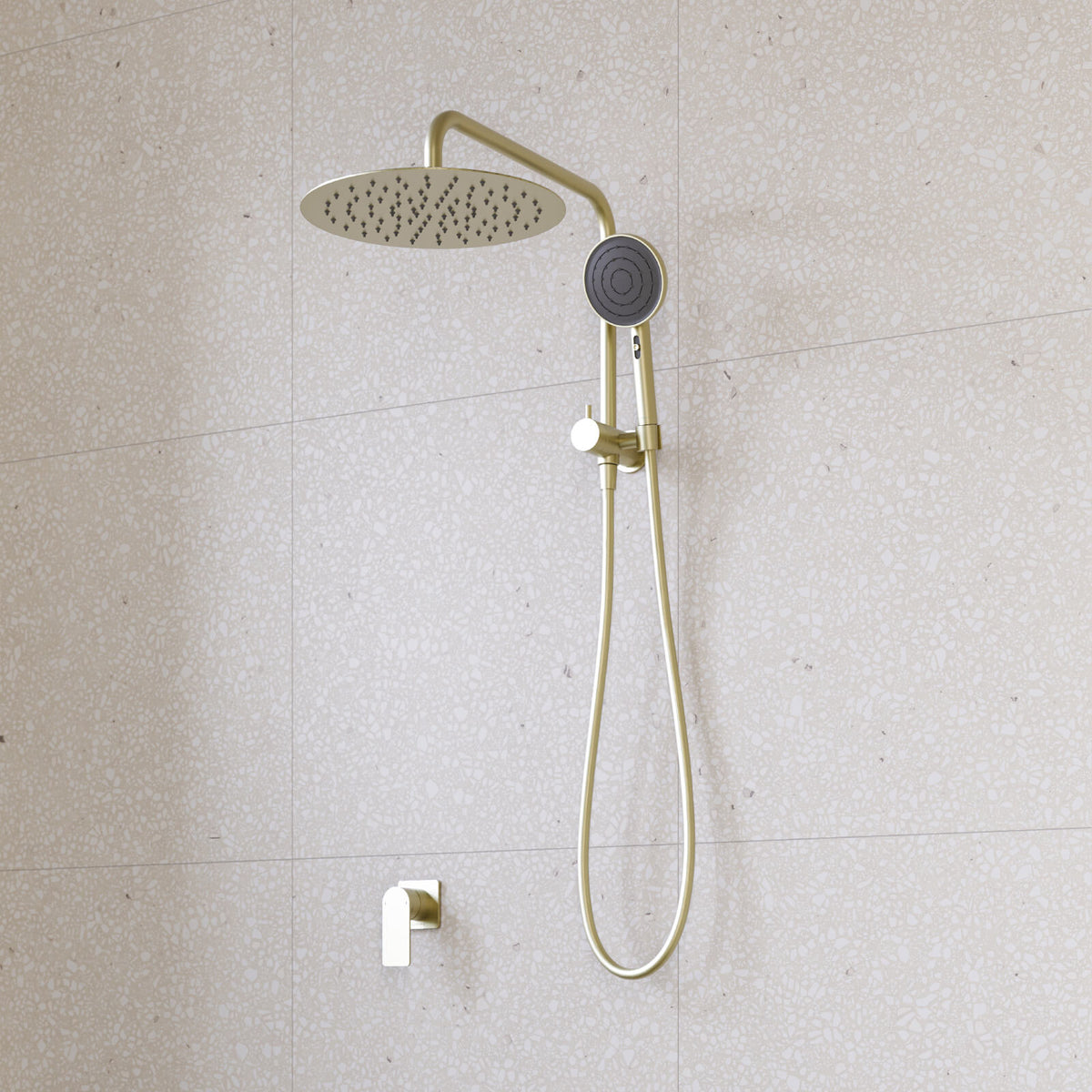 Caroma Urbane II compact twin shower in brushed brass, with round overhead rain shower, hand shower and hose on tiled wall