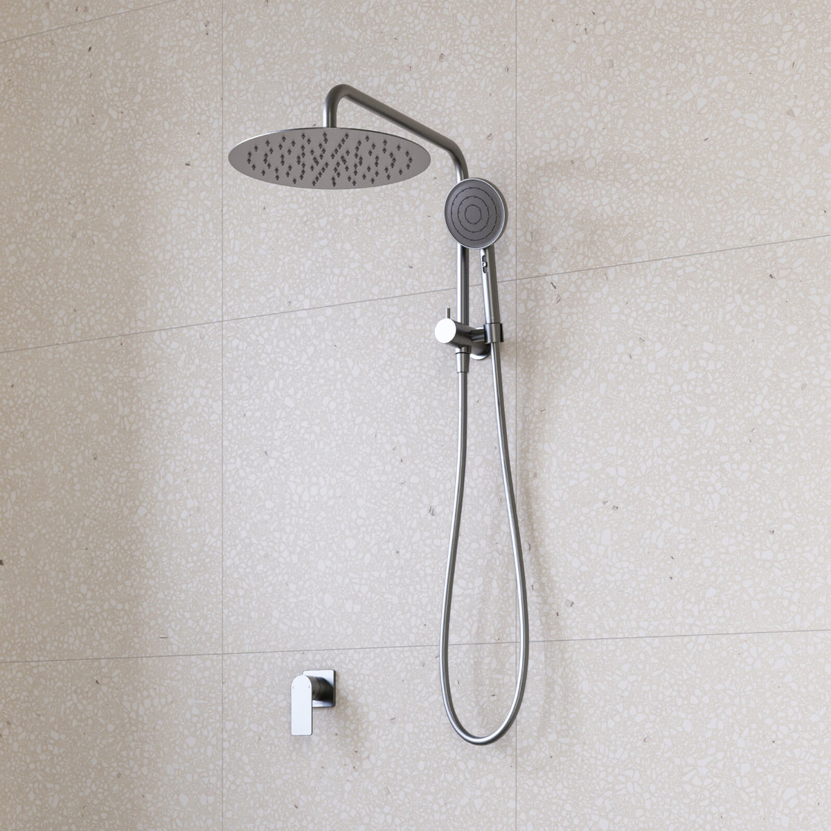 Caroma Urbane II twin shower in gunmetal, with round overhead rose, handset and wall mixer on tiled bathroom wall