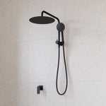 Caroma Urbane II matte black twin shower with round overhead rose, hand shower and hose on tiled wall
