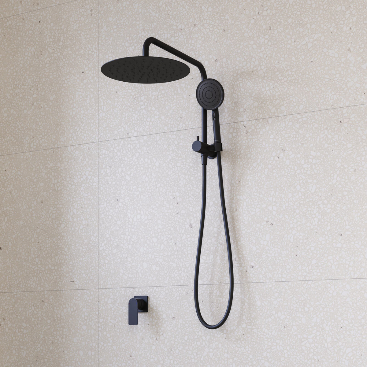Caroma Urbane II matte black twin shower with round overhead rose, hand shower and hose on tiled wall