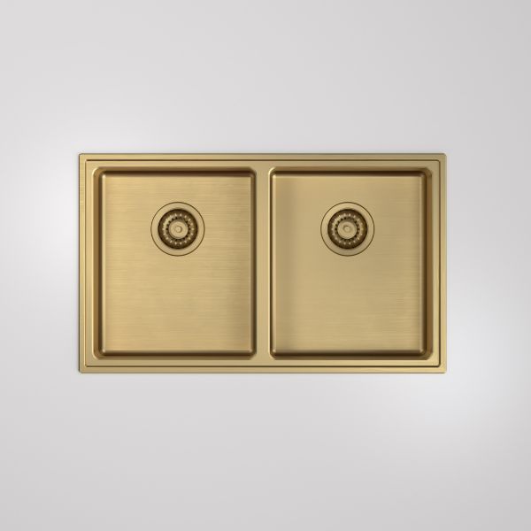 Caroma Urbane II double bowl kitchen sink in brushed brass, top view with two square bowls and basket wastes