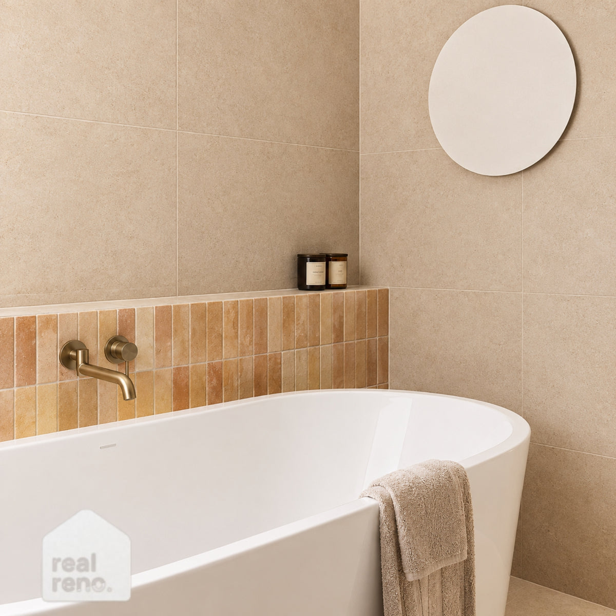 Caroma Urbane II white freestanding oval bath in a beige tiled bathroom with brushed brass tapware