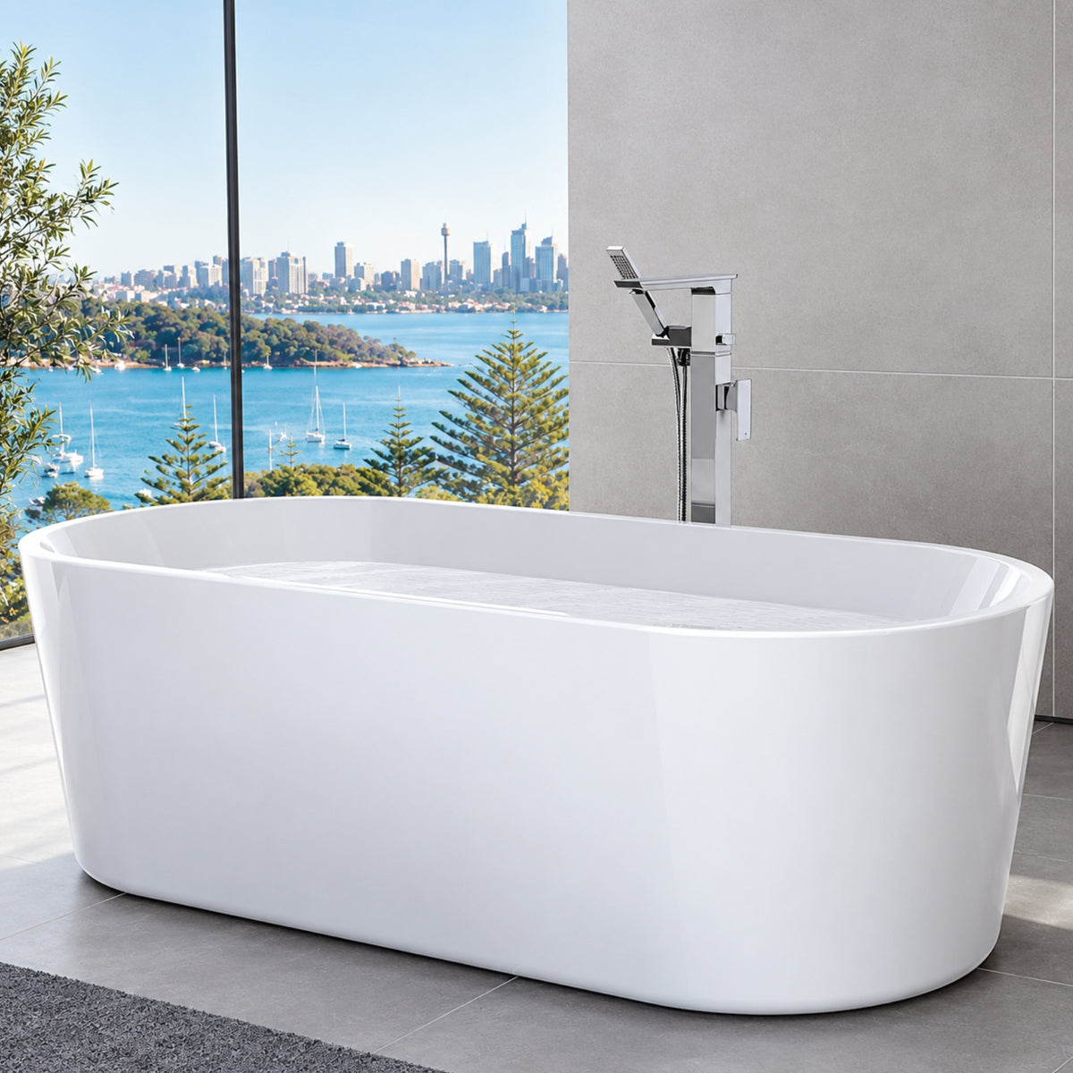 Caroma white freestanding oval bath in a modern bathroom with floor-mounted tap and harbour view