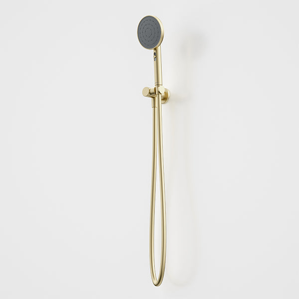 Caroma Urbane II hand shower in brushed brass with round shower head and hose, wall mounted on white background
