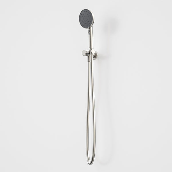 Caroma Urbane II round hand shower in brushed nickel with wall bracket and hose on a white background