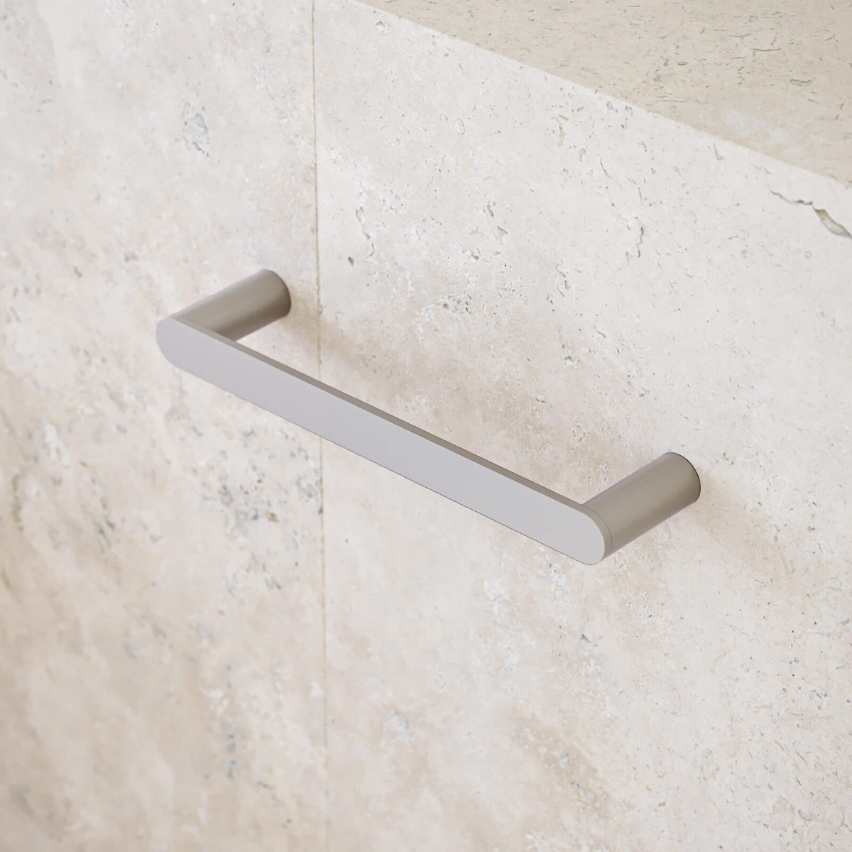 Caroma Urbane II brushed nickel hand towel rail on a light stone bathroom wall, slim modern wall-mounted design