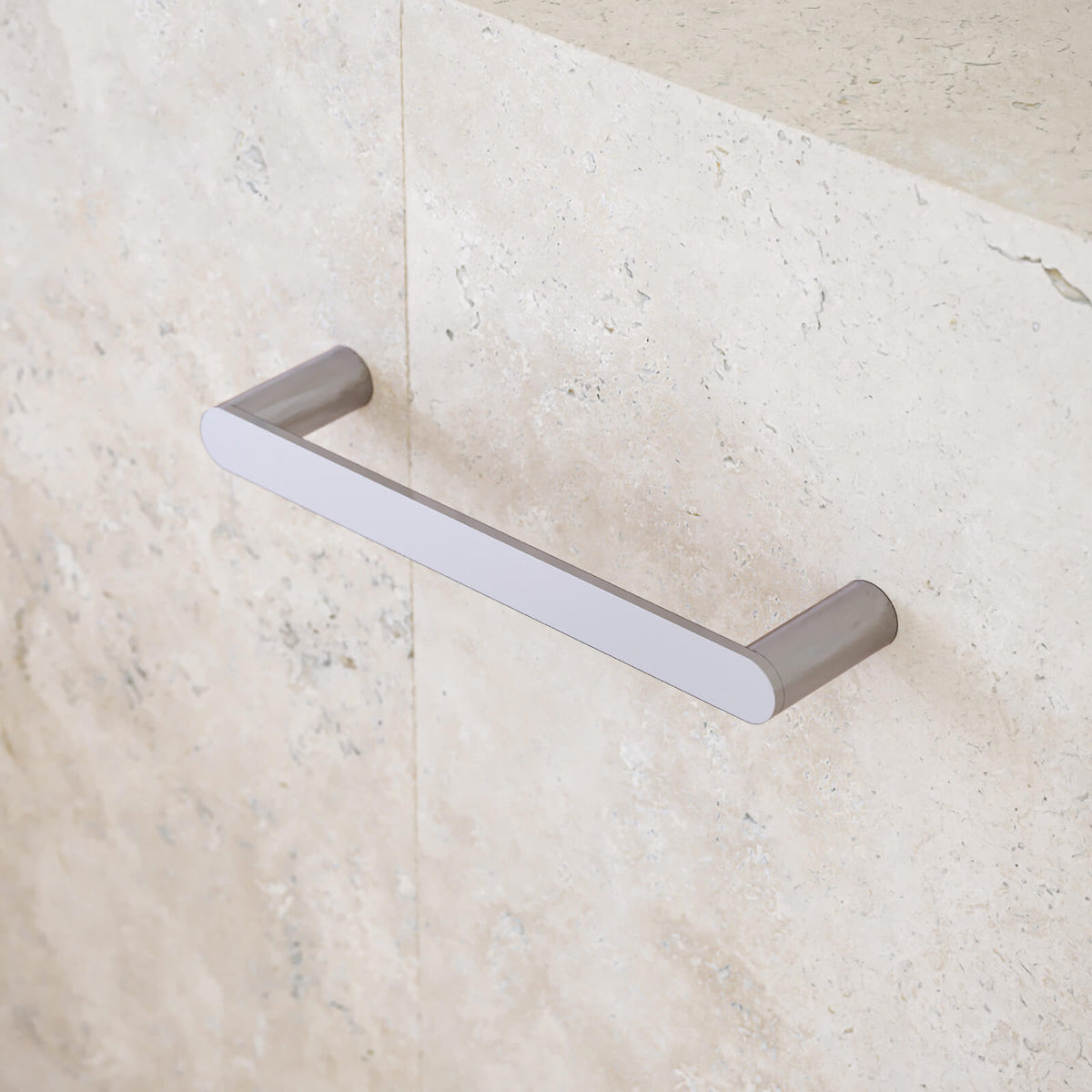 Caroma Urbane II chrome hand towel rail on a stone-look bathroom wall