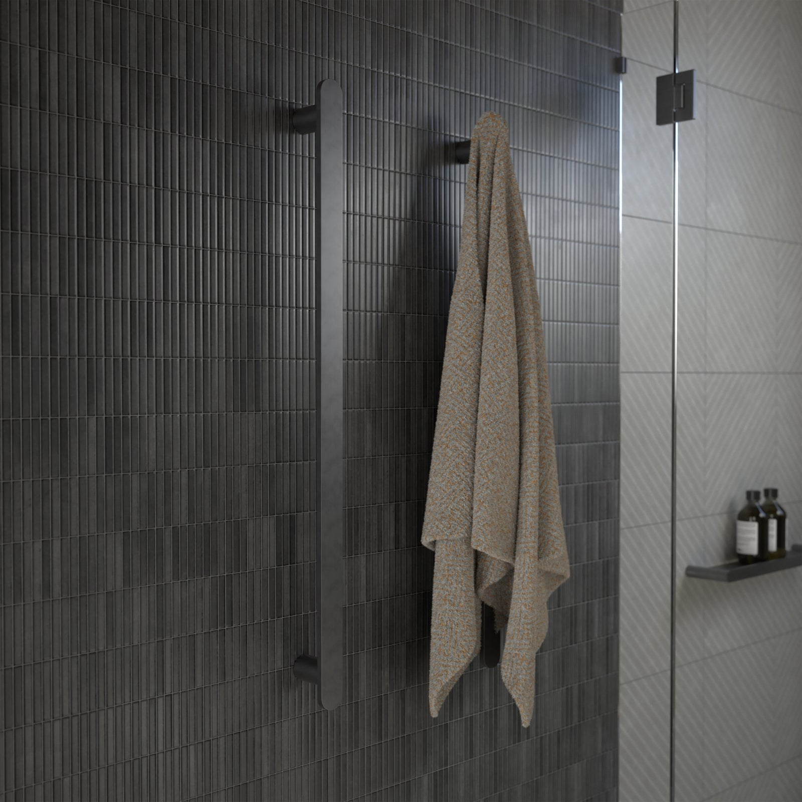 Caroma Urbane II vertical heated towel rail in gunmetal, shown in a bathroom with towel hanging on the single bar