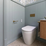 Caroma white wall-faced bidet suite in a modern bathroom, with concealed cistern and flush plate visible