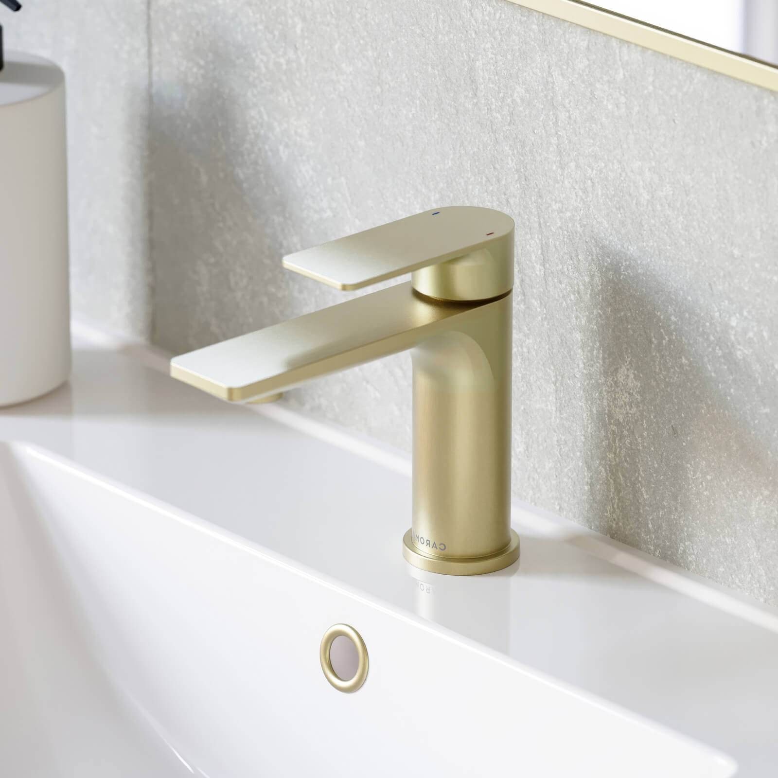Caroma Urbane II basin mixer in brushed brass, shown mounted on a white bathroom vanity basin