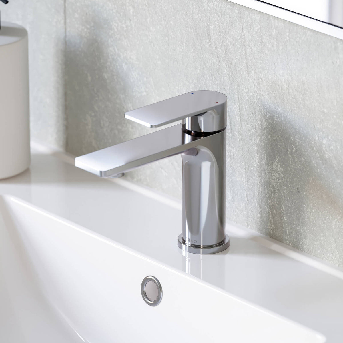 Caroma Urbane II chrome basin mixer on a white hob-mounted basin, shown in a bathroom vanity setting