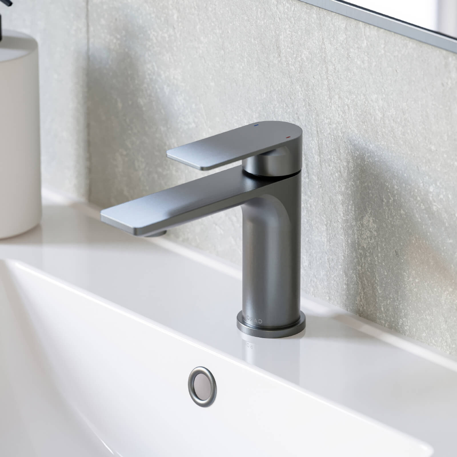 Caroma Urbane II basin mixer in gunmetal, hob mounted over a white bathroom basin