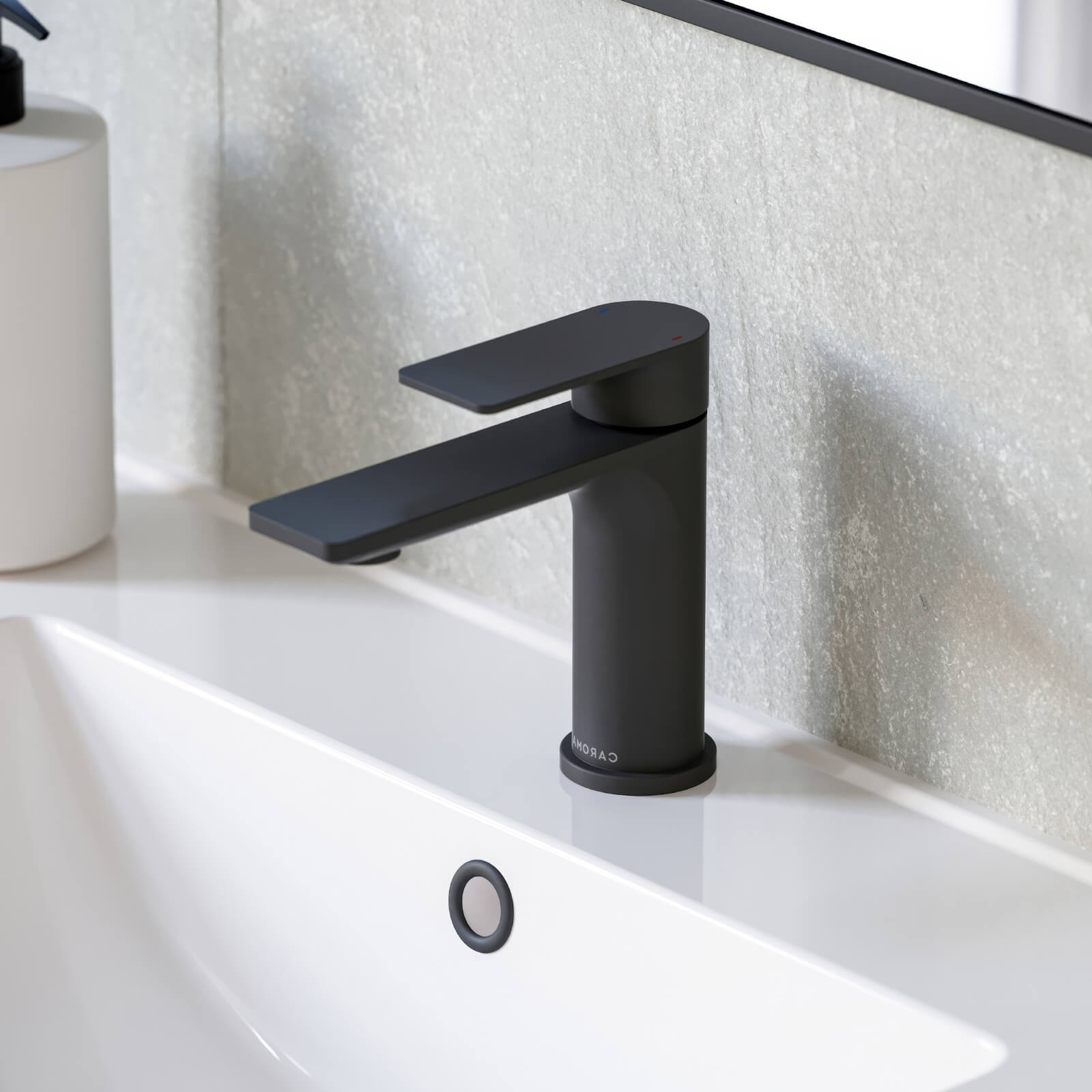 Caroma Urbane II matte black basin mixer on a white bathroom basin, side view, hob mounted tap