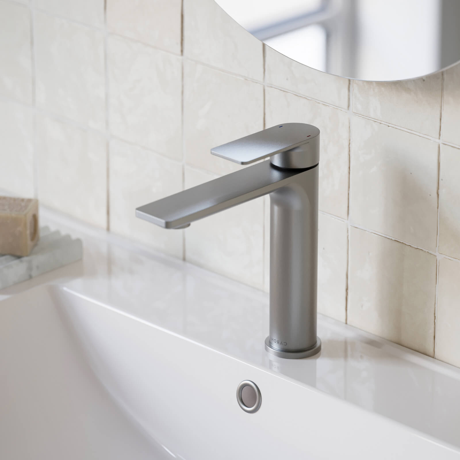 Caroma Urbane II mid tower basin mixer in brushed nickel, hob mounted on a white bathroom basin.