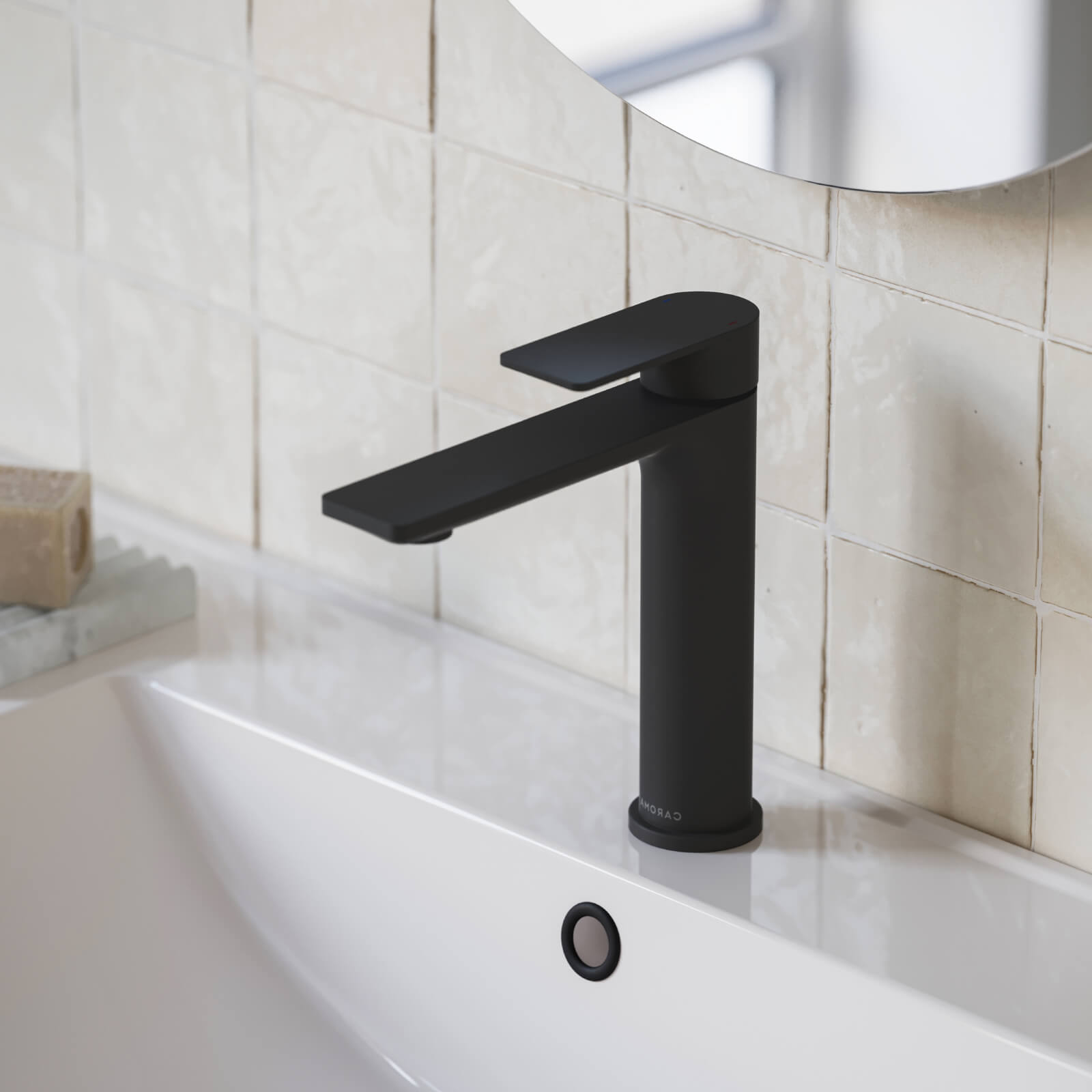 Caroma Urbane II mid tower basin mixer in matte black, shown installed on a bathroom basin sink.