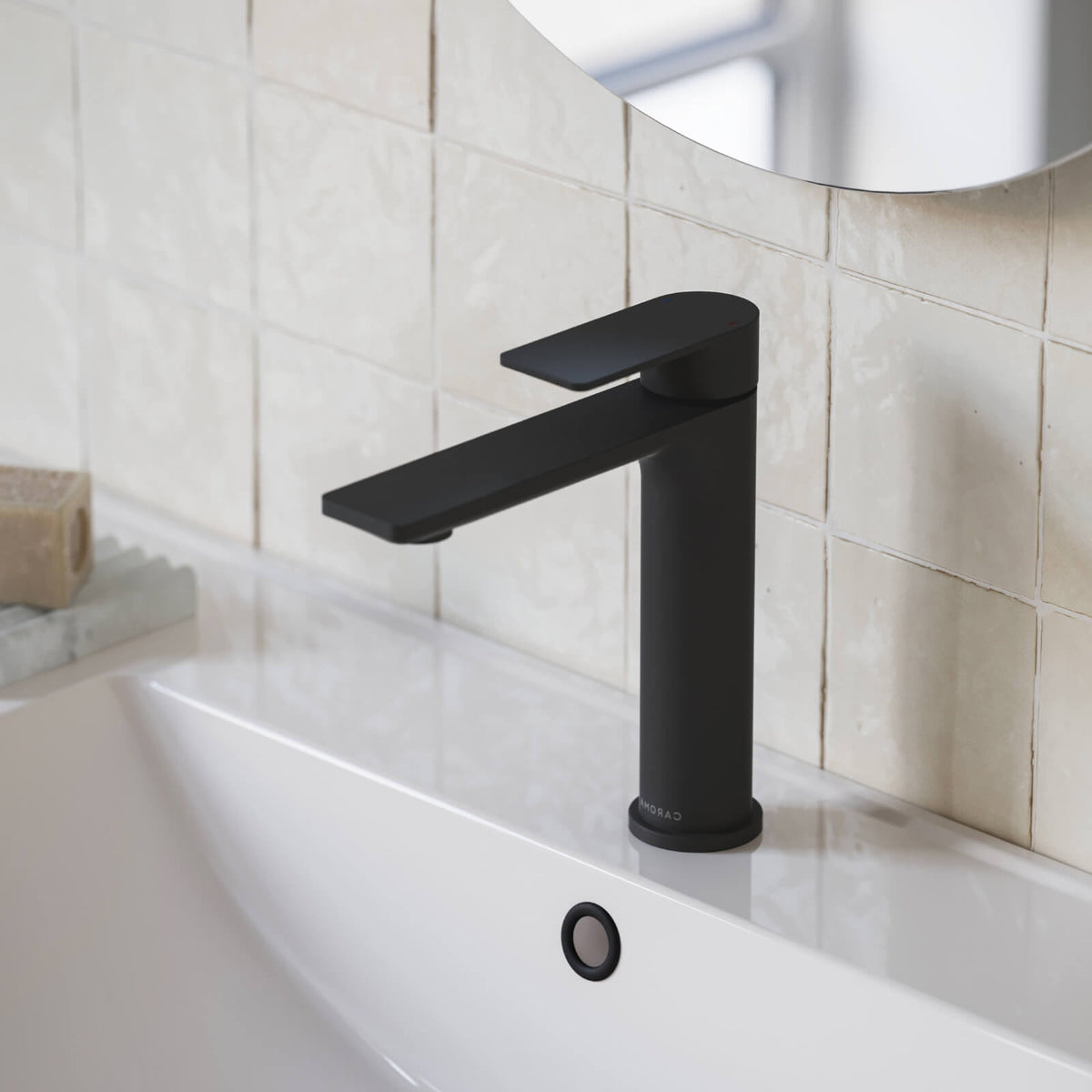 Caroma Urbane II mid tower basin mixer in matte black, shown installed on a bathroom basin sink.