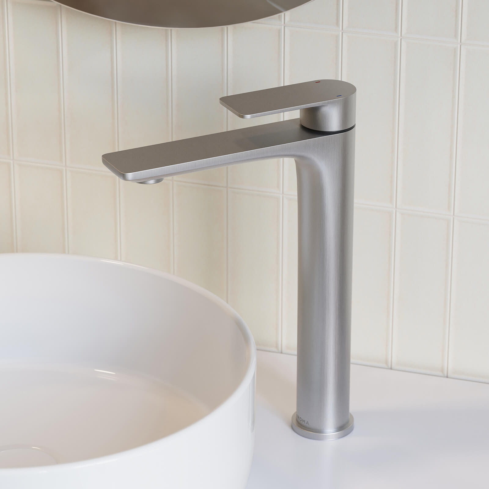 Caroma Urbane II tower basin mixer in brushed nickel, shown with a white vessel basin in a bathroom setting