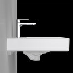 Caroma Urbane II white wall-hung basin with left-hand shelf and chrome mixer tap, side view