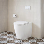 Caroma Urbane II Luxe wall-faced toilet suite in white with concealed cistern and flush plate in a tiled bathroom.