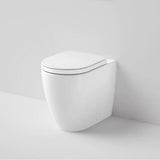 Caroma white wall-faced toilet pan with soft-close seat, shown in a minimal studio setting, front angle