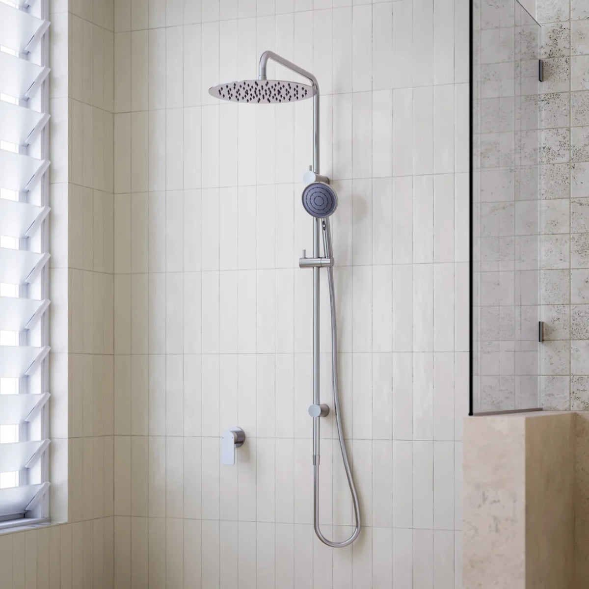 Caroma Urbane II chrome twin rail shower with overhead rain shower and hand shower in a tiled bathroom