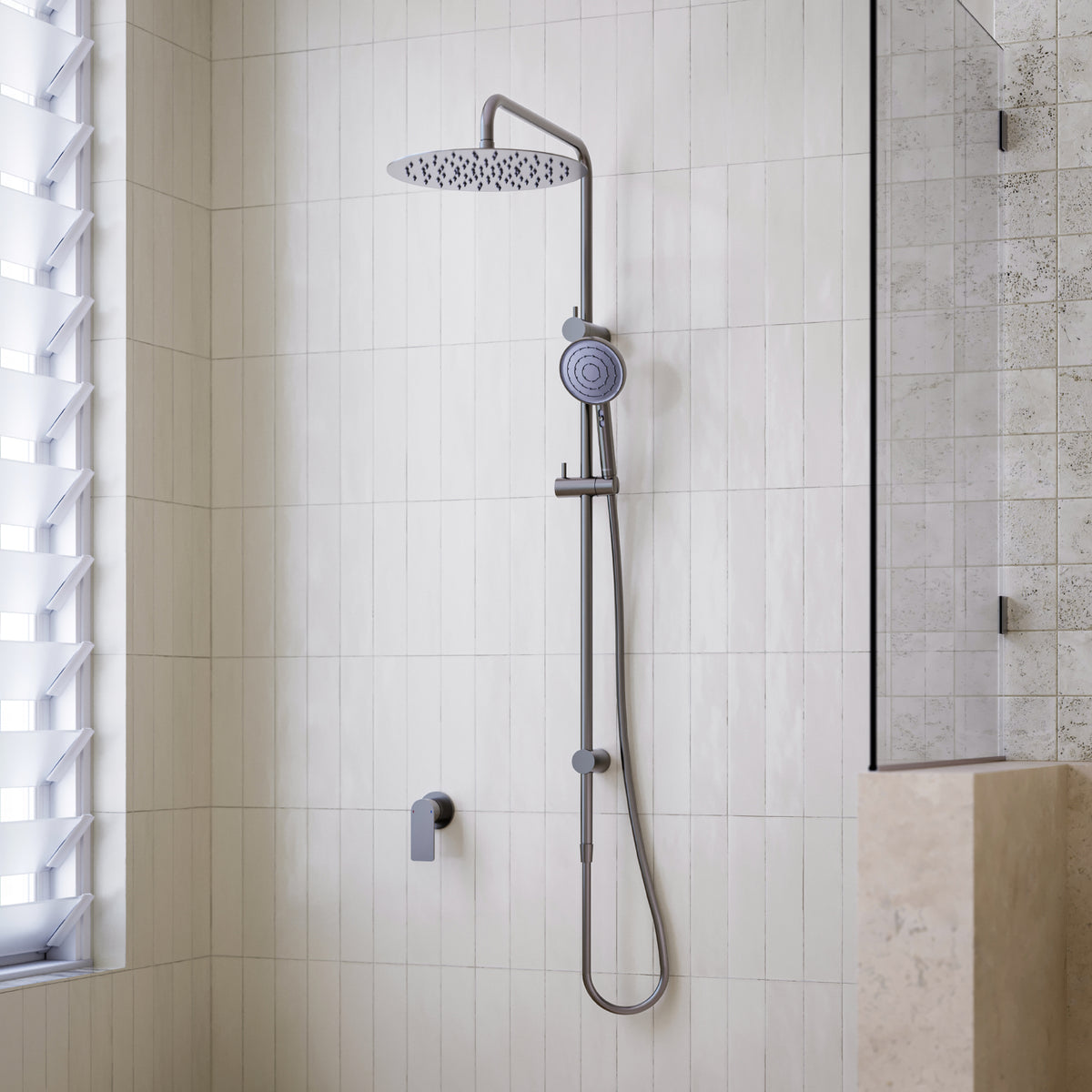 Caroma Urbane II twin rail shower in gunmetal, with round overhead drencher and hand shower in a tiled bathroom