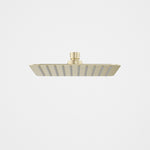 Caroma 200mm square rain shower head in brushed brass, front view on white background