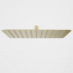Caroma 300mm square rain shower head, brushed brass finish, low-profile overhead view