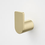 Caroma Urbane II robe hook in brushed brass, wall-mounted with slim rounded rectangular backplate and cylindrical peg
