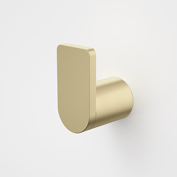 Caroma Urbane II robe hook in brushed brass, wall-mounted with slim rounded rectangular backplate and cylindrical peg