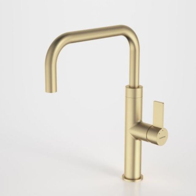 Caroma Urbane II gooseneck sink mixer in brushed brass, side lever tap on white background