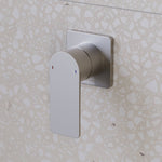 Caroma Urbane II square wall-mounted bath/shower mixer in brushed nickel on terrazzo-look bathroom tile