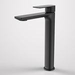 Caroma Urbane II tower basin mixer in matte black, with tall cylindrical body and slim flat spout on white background