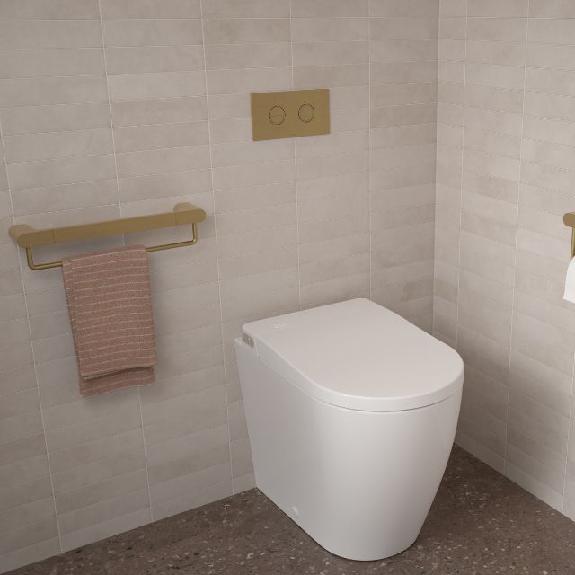 Caroma Urbane II brushed brass straight rail mounted in a tiled bathroom beside a toilet, with towel hanging below