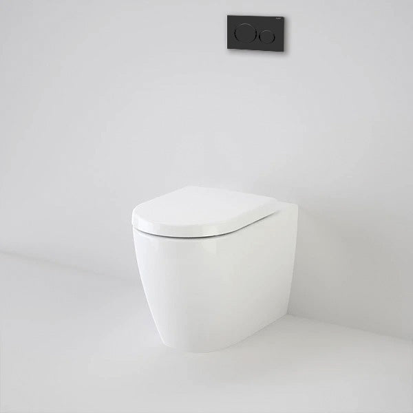 Caroma Urbane wall-faced white toilet pan with black flush plate in a minimalist bathroom setting