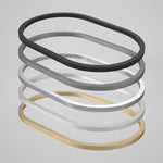 Caroma Liano II pill inset basin trim rings in matte black, grey, white and brushed brass finishes, stacked on grey background